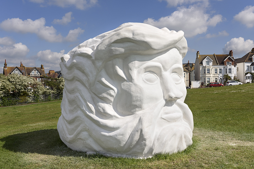 A sculpture, which presents two faces — one faced inland and the other gazing at the sea