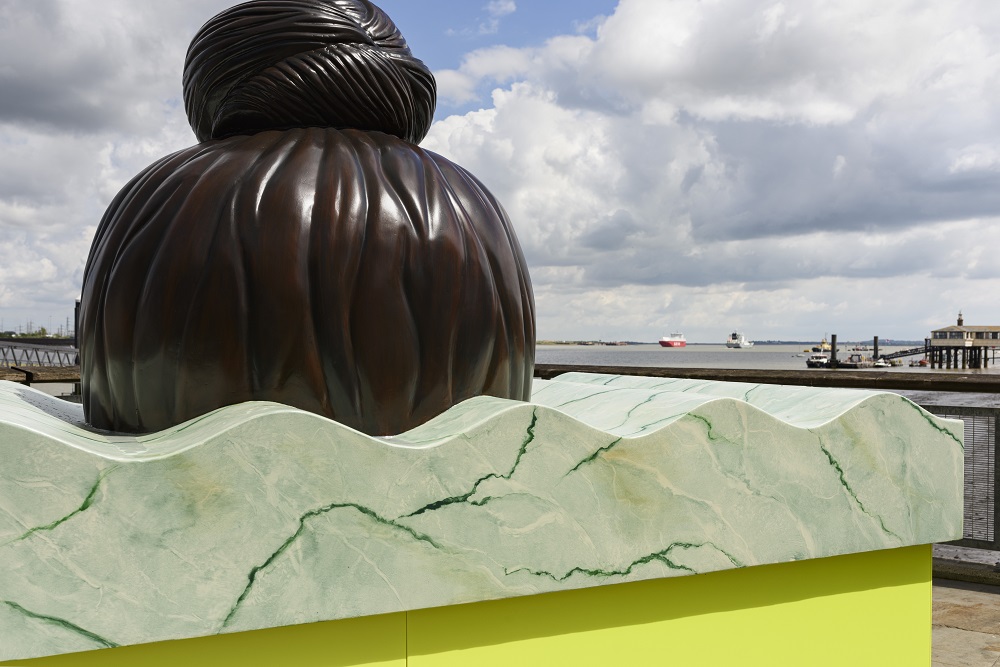 A large-scale semi-abstract sculpture that features several components and includes a structure that resembles the top of a Sikh head including a top-knot.